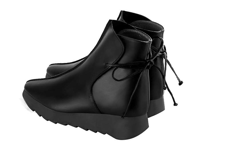 Satin black women's ankle boots with laces at the back. Square toe. Low rubber soles. Rear view - Florence KOOIJMAN